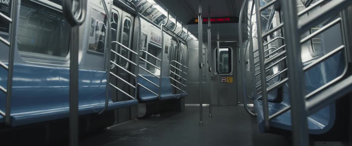 Empty seats in a train car as it travels through the subway