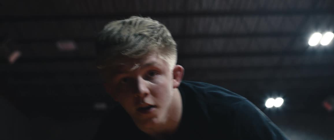 A teen wrestler shuffles left and right while preparing to fight