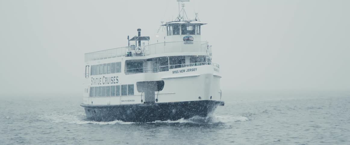 A ferry travels in the water during a storm