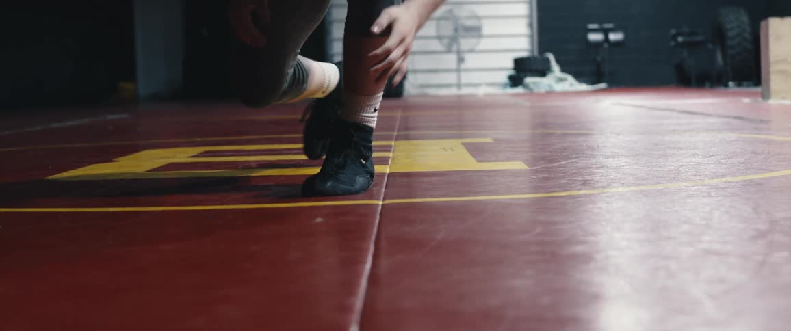 A man is wrestling in the gym
