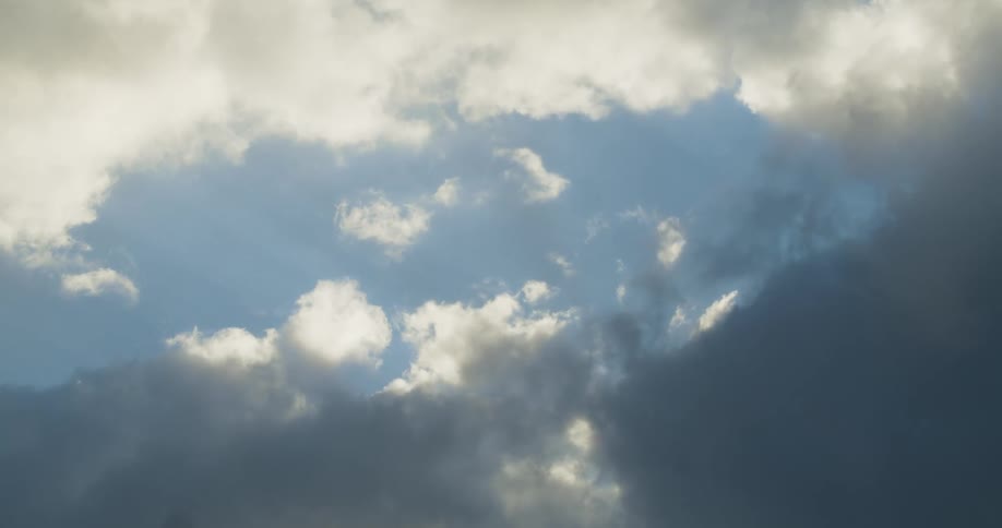 Dark clouds moving across a blue sky