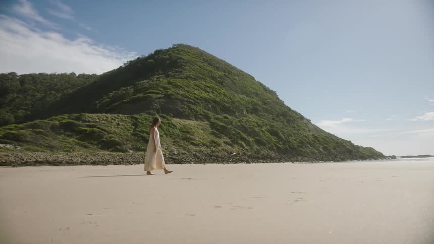 A woman walks on the beach