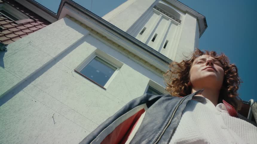 A woman is standing outside of the building