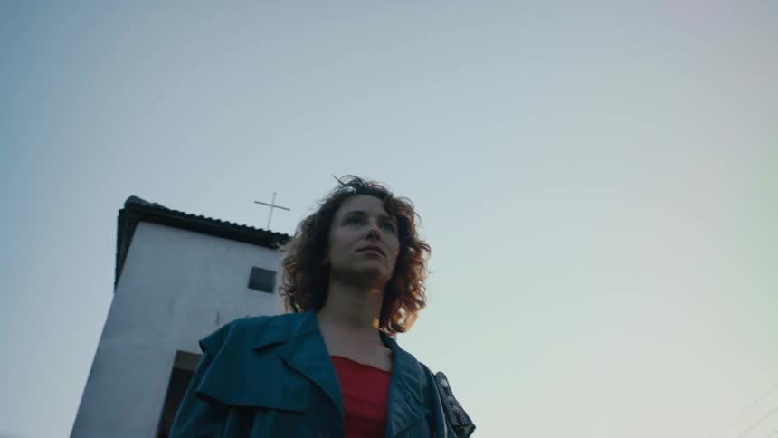 A woman walks away from a church
