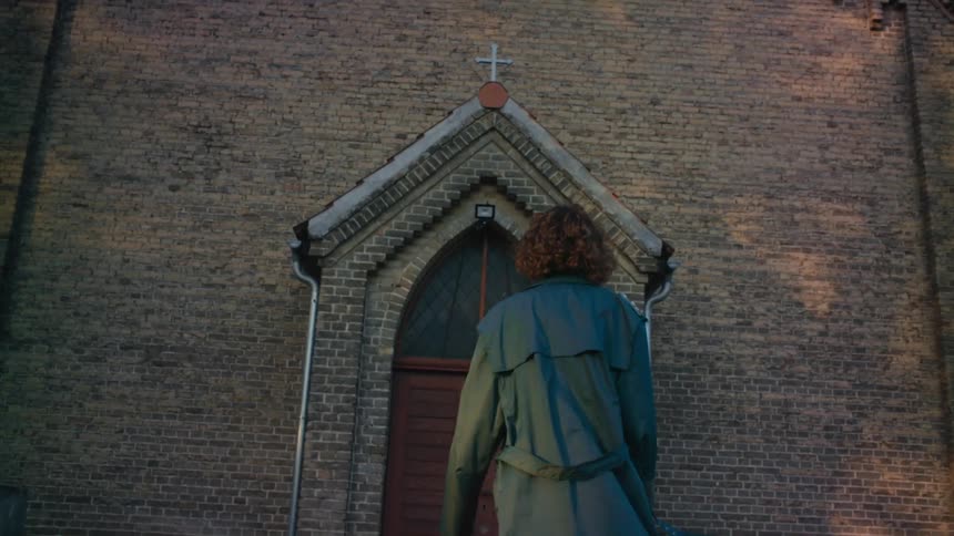 A woman walks into the church