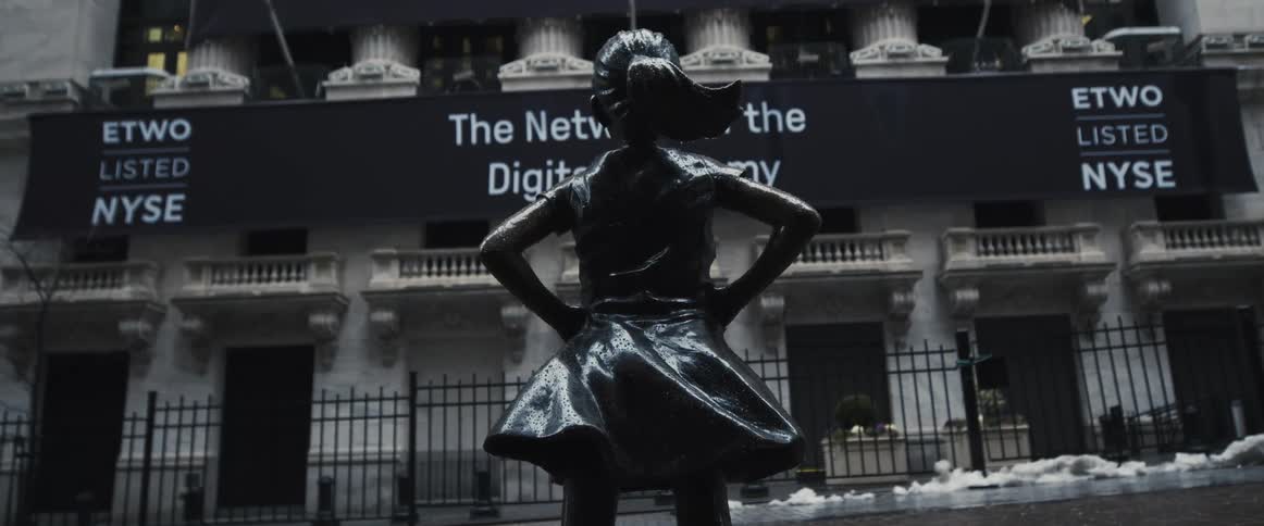A statue in front of a building in a city