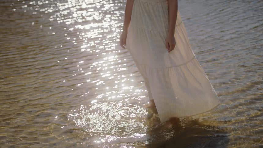 A woman wades in the water