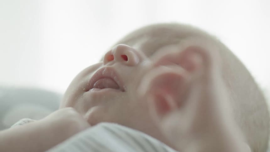 Close up of a baby laying down awake