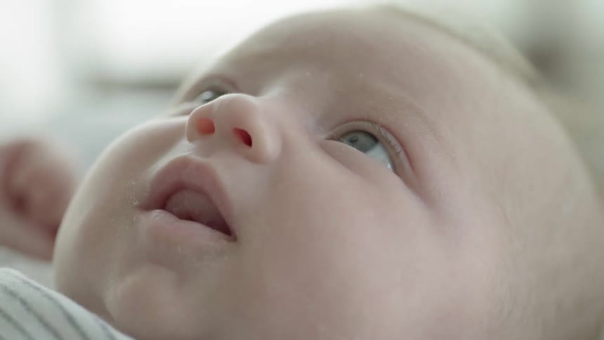A baby tries to focus