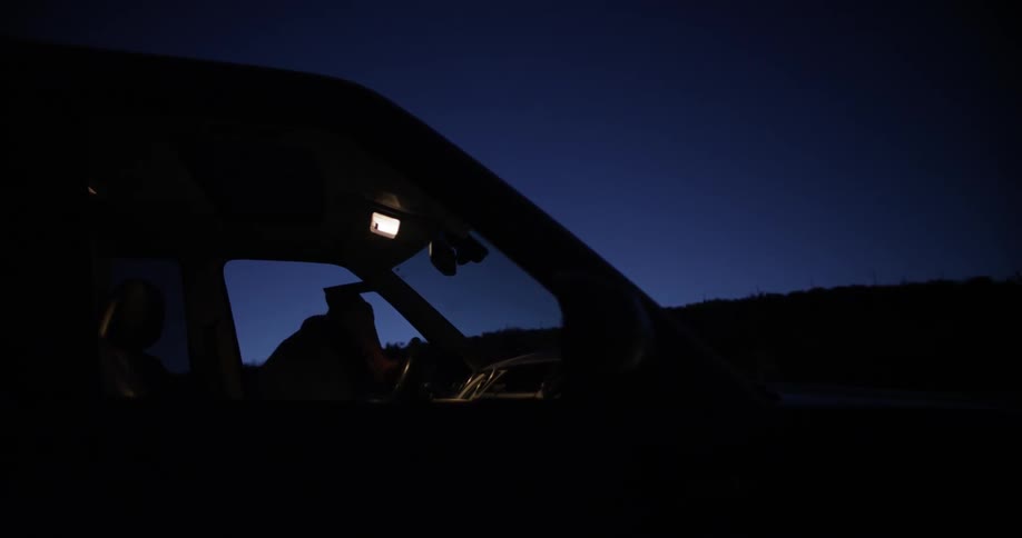 A man exiting an suv at night