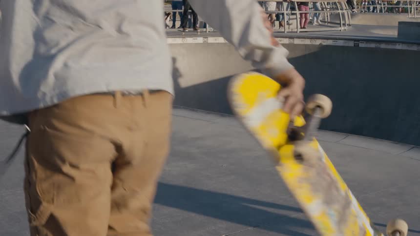 A group of people are at a skatepark in spring
