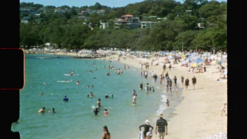 The beach is full of people on vintage film