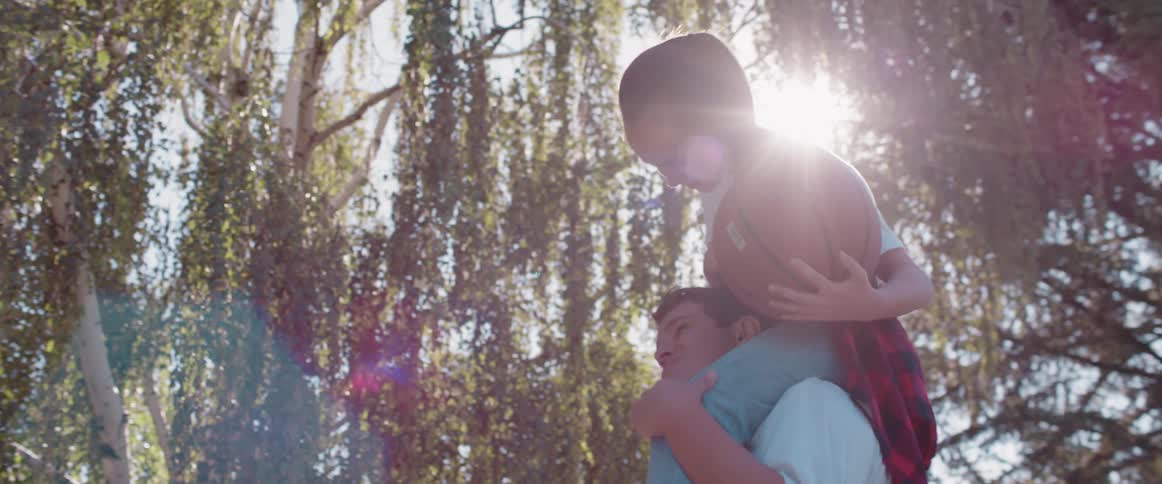 A child and father playing basketball