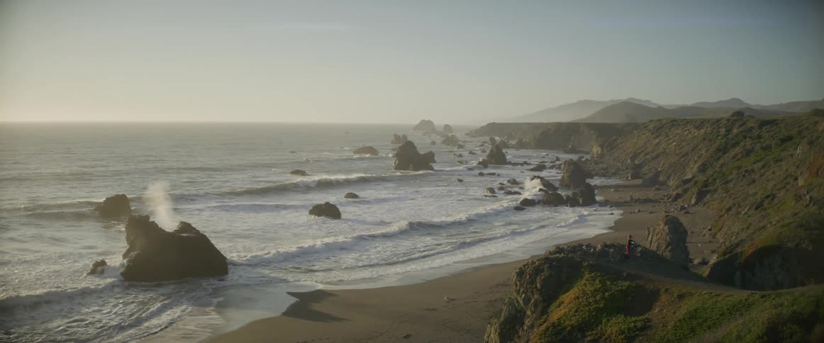 Ocean waves splash and crash against rocks near shore