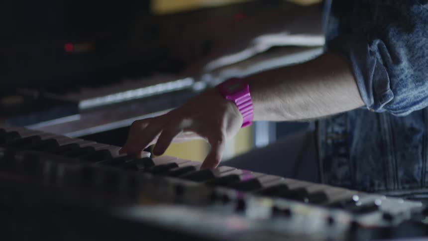 Man playing a keyboard in a studio