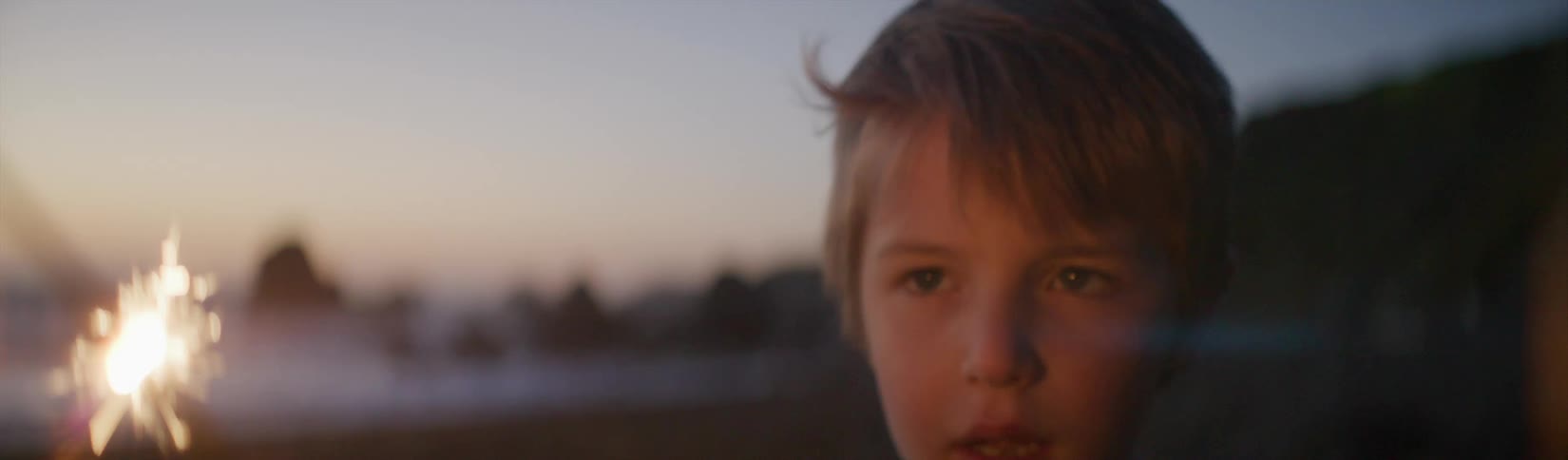 A view of a child playing with a sparkler
