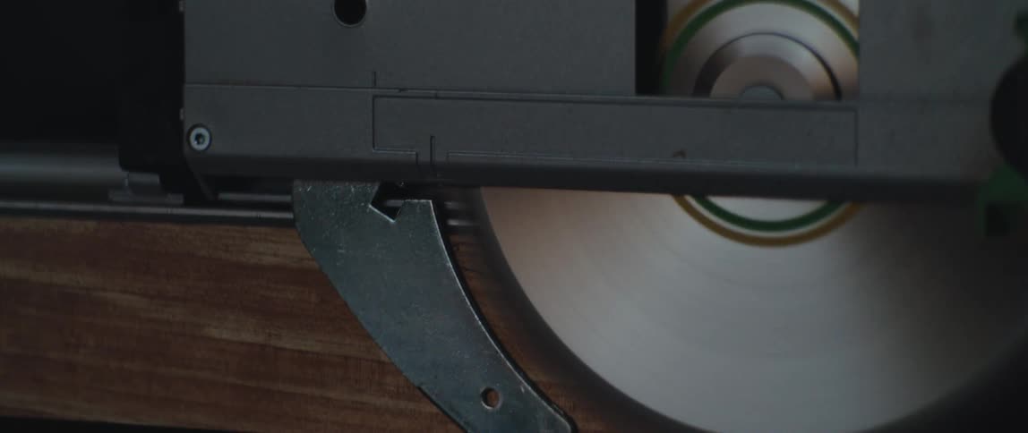 A saw cutting a piece of wood