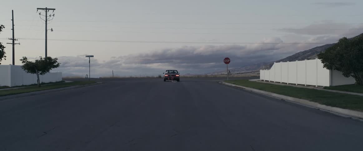 Newlyweds driving off into the sunset after wedding reception