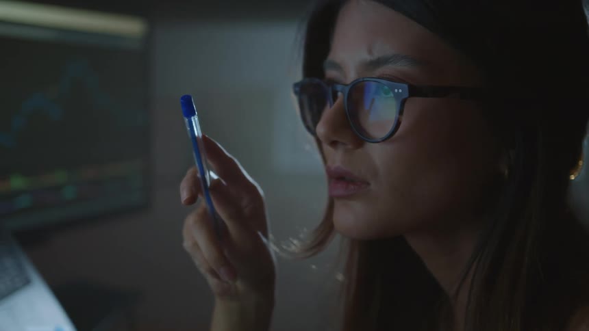 A woman working in an office looking at a computer