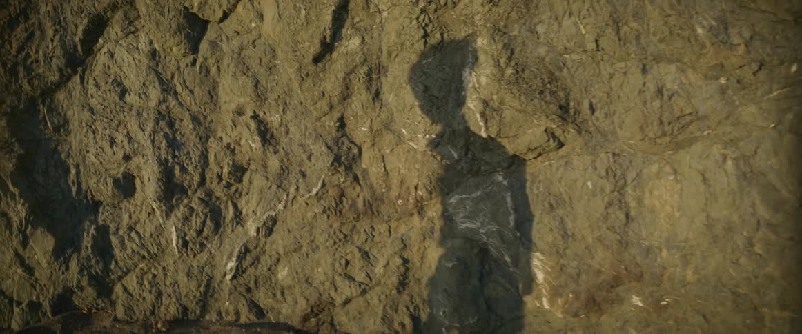A shadow of a child is reflecting on the rock