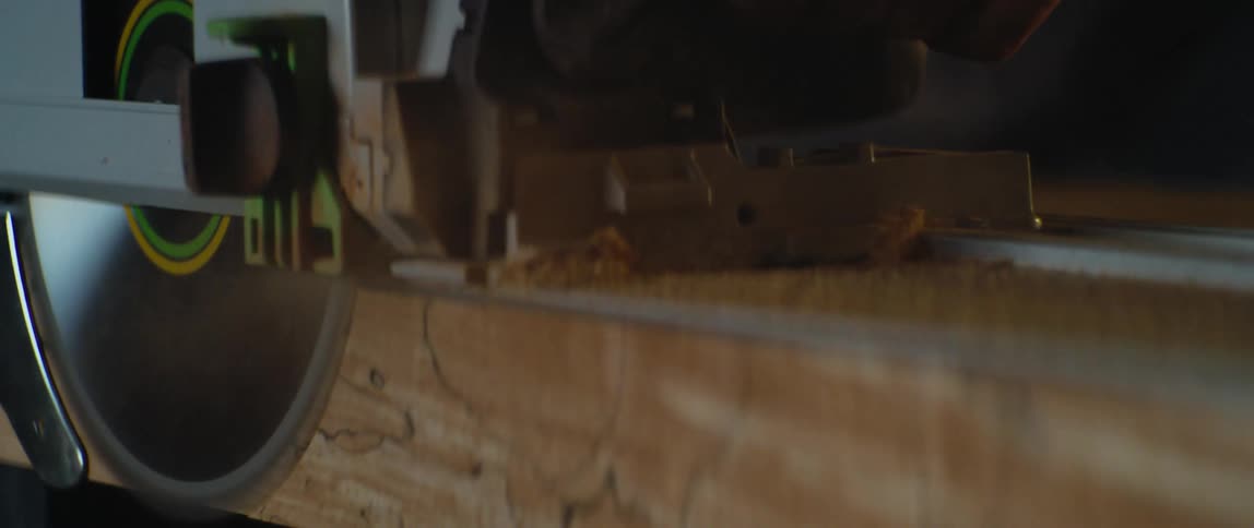 A power saw cutting through a piece of lumber