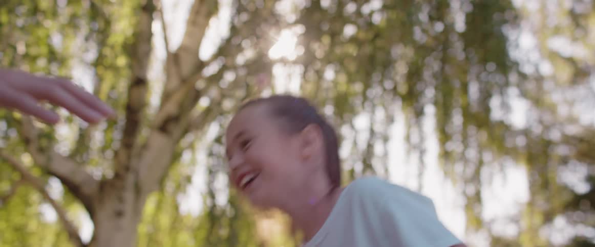 Young girl playing basketball with a dad bouncing the ball and then throwing it and scoring a point