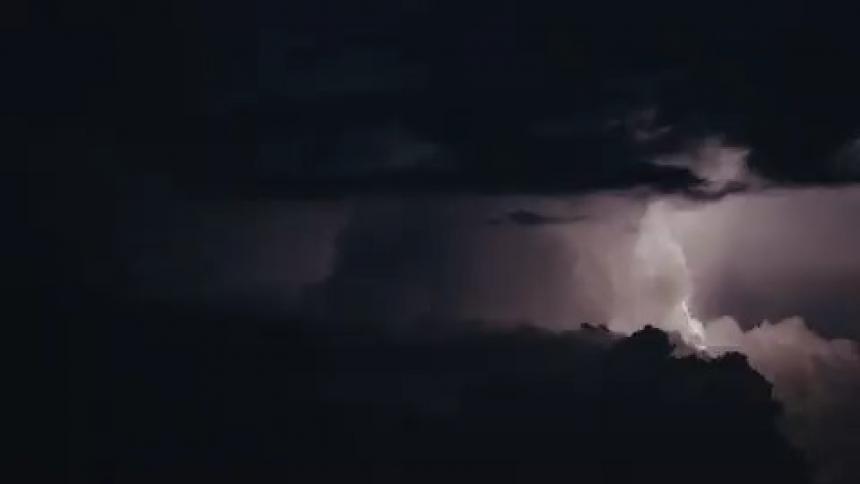 Thunder and lightning is shown outdoors at night