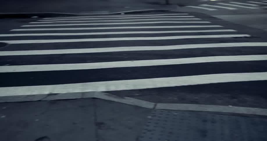 Wide crosswalks sit perpendicular in a parking lot