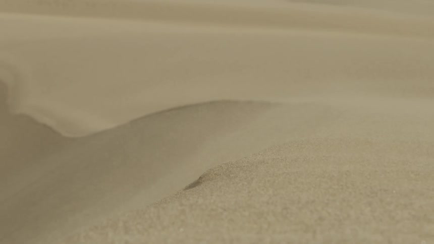 Sand blows across the desert on a windy day
