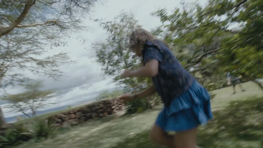 Two children run around outside