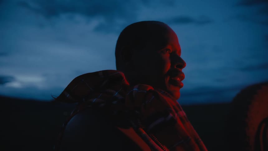 A man is standing outdoors at night