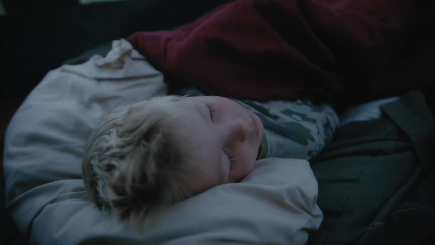 A child is sleeping in bed