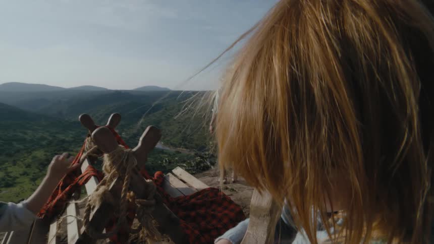 A family are setting up camp on the mountain
