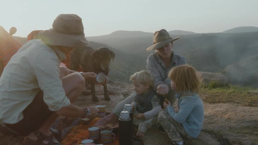 A family is sitting outdoors at cooking in spring