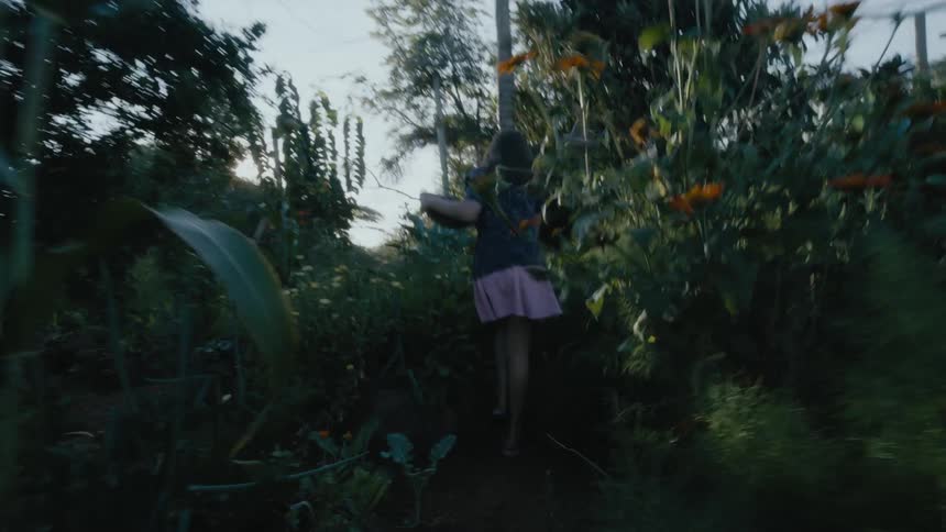 A girl collects stuff in the garden
