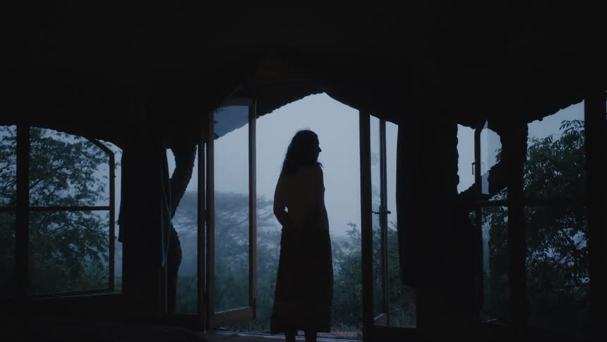 A woman is standing by a balcony in spring