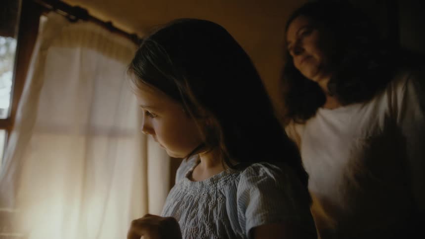 A mother is brushing her daughters hair