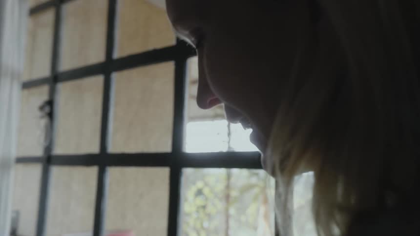 A woman bathes her baby in a plastic tub