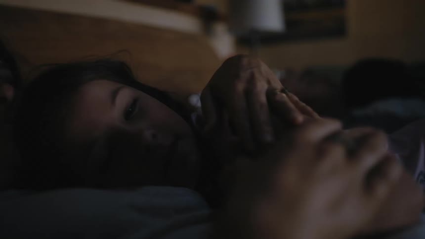 Mother and daughter lying together in the bed and relaxing
