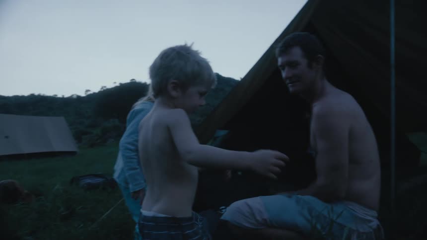 A family are camping by the stream