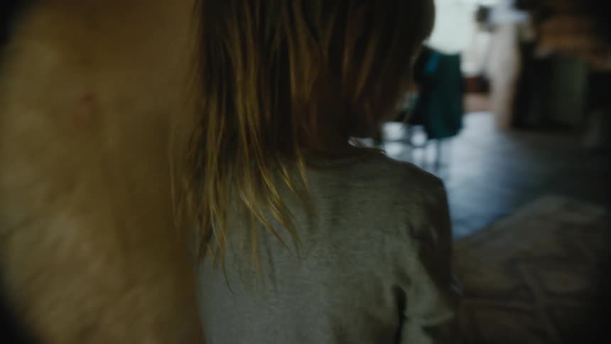 A woman places an object in a childs hands to carry into a restaurant