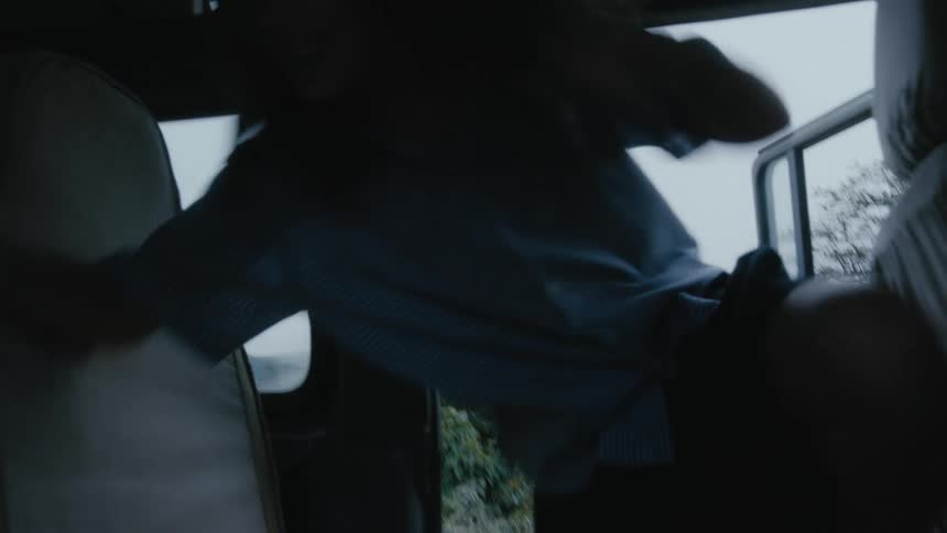 A girl opens the back door of a land rover and jumps in joyfully