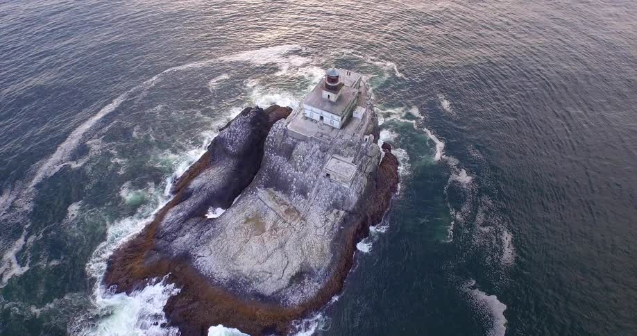 Aerial view of a small island with a building on top of the rocks