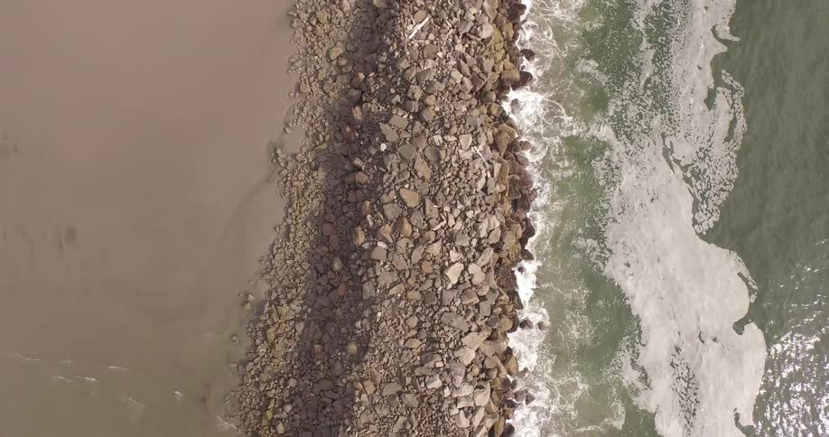 Aerial view of a rocky barrier separating bodies of water