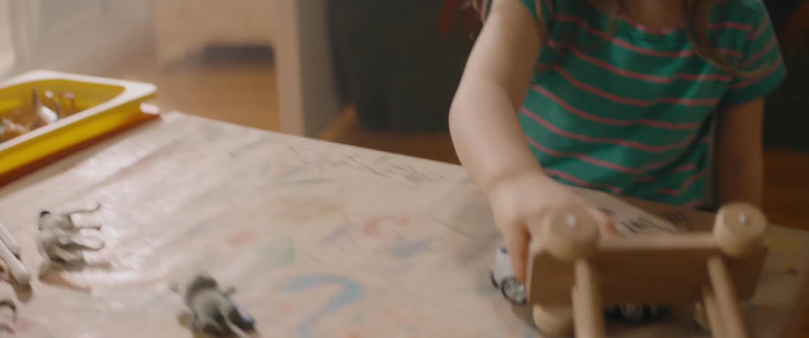 A child playing with a toy car