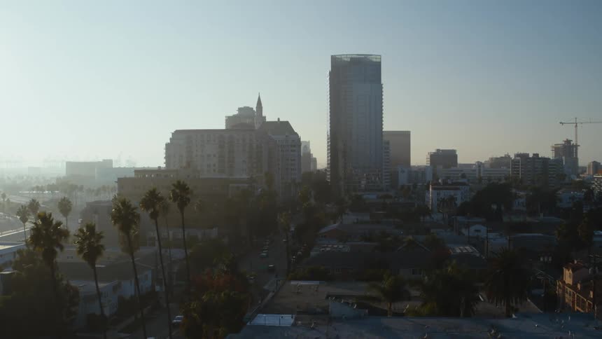 A skyscraper looms over a metropolis during the day