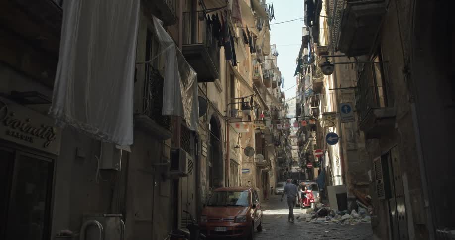 A view of a man walking in an alley