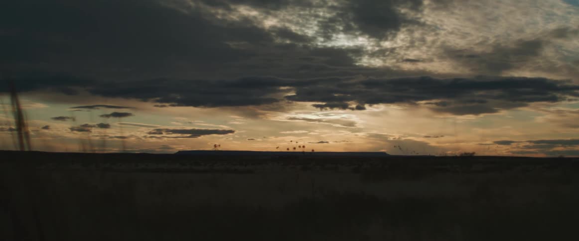 The sun is setting in the open horizon