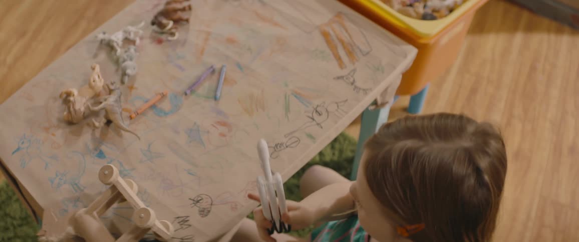 A little girl playing with a toy rocket