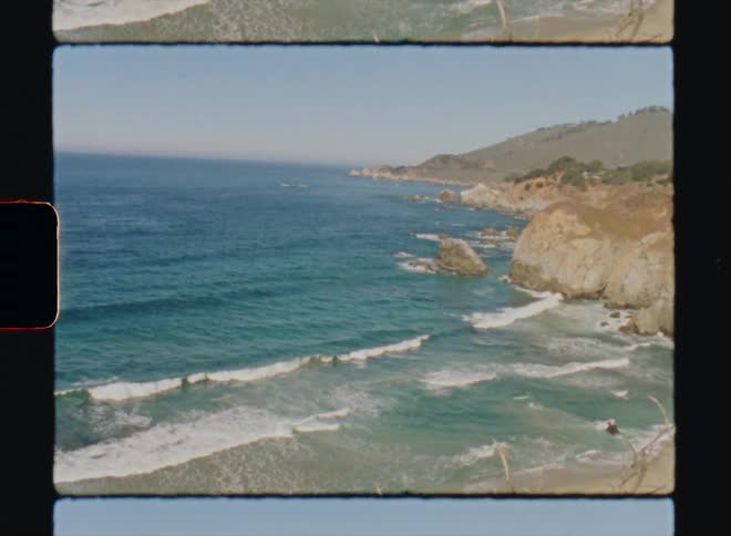 Waves roll into shore and over a beach and rocks Big Sur California Super8 4k Film Scan